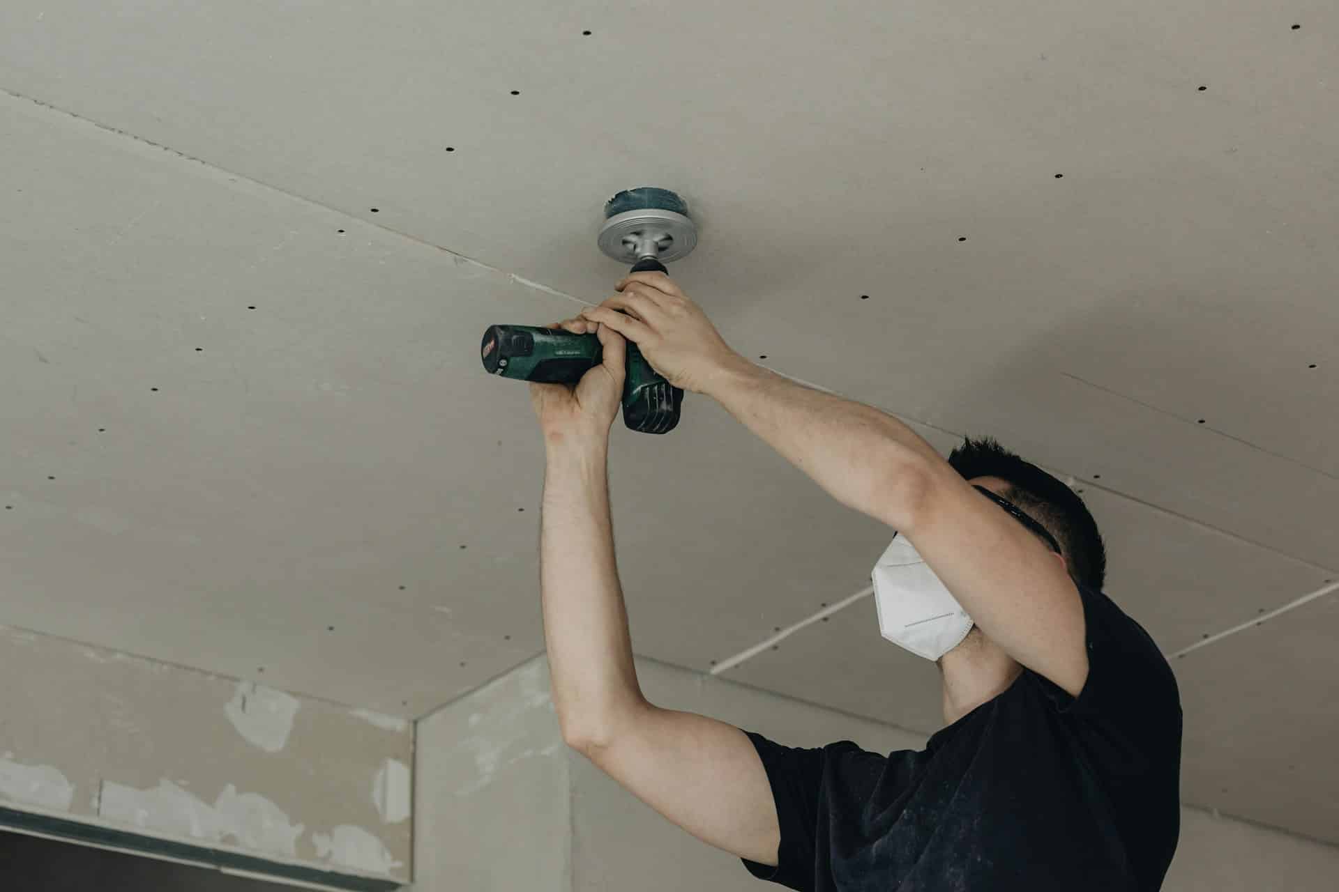 electrician working on light fixture